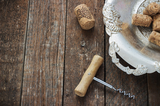 corkscrew and cork from wine on a wooden background