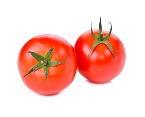 two fresh tomatoes with green leaves isolated on white backgroun