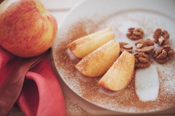 apple is sliced into wedges with cinnamon.