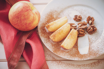 apple is sliced into wedges with cinnamon.