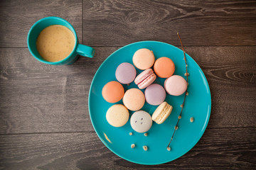 Beautiful Multicolored Macarons on the plate with coffee