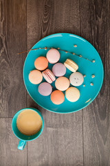 Beautiful Multicolored Macarons on the plate with coffee