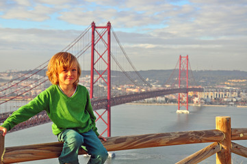 Smiling boy at the Golden bridge, Lisbon