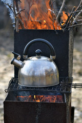the whistling kettle begins to boil on a brazier