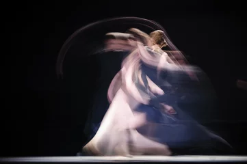 Foto op Plexiglas Blurry dancers in dynamic dance. Dancers dance on the dark stage. Slow shutter speed photography. . © ryszard filipowicz