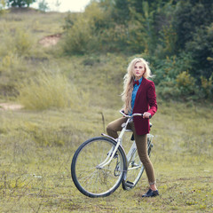Fototapeta premium beautiful blonde and vintage bike