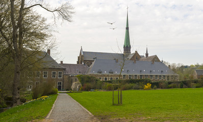 Footpath through the park of an abbey in spring