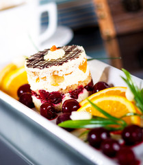Cake on a white plate with fresh fruit