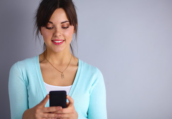 Woman using and reading a smart phone