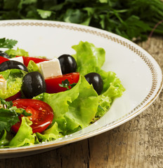 salad with tomatoes, olives and cheese, selective focus
