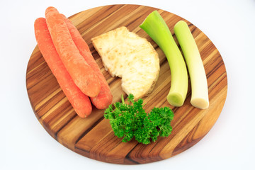 Mirepoix on wooden cutting board with white background