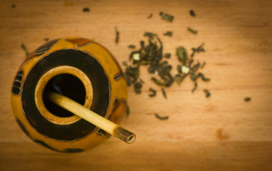 herbal tea mate in kalabas on wooden board, blured