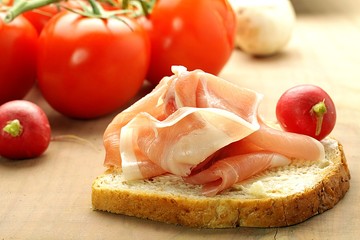 ham sandwich on a background with tomatoes