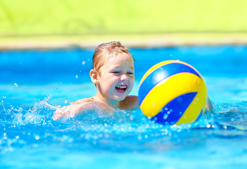 cute kid playing in water sport games in pool