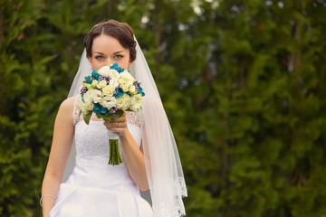 Beautiful bride outdoors in a forest.