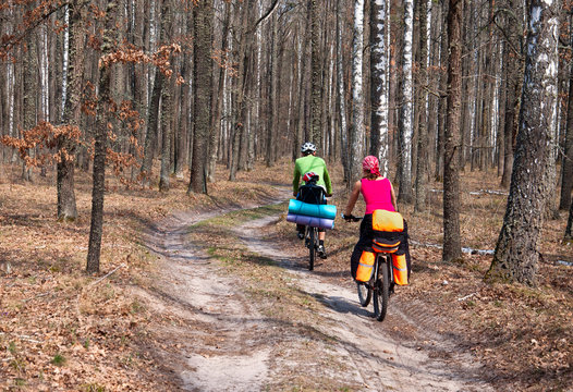 Man, woman and child practicing mountain bikes on a forest trail