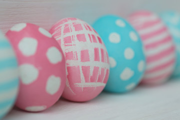 Pink and blue eggs on a wooden background