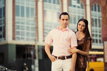 Young couple hug and kiss in city centre
