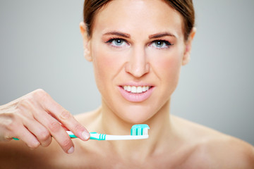 beautiful girl brushes her teeth