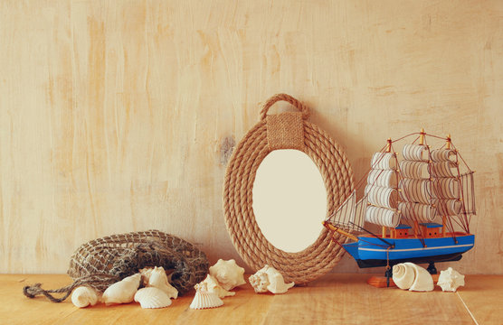  Vintage nautical frame from ropes, wooden boat and natural seas