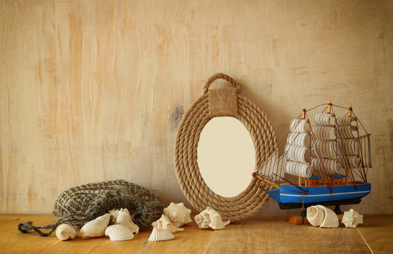  Vintage nautical frame from ropes, wooden boat and natural seas