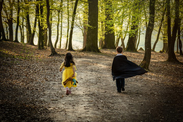 boy with cape and girl in princess dress