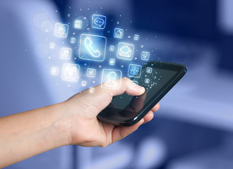 Hand holding smartphone with mobile app icons