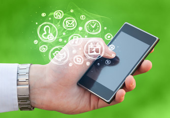 Hand holding smartphone with mobile app choices