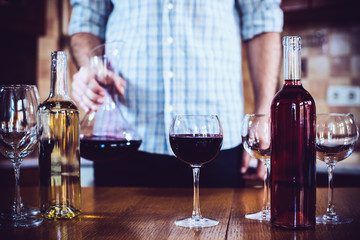 man pours red wine