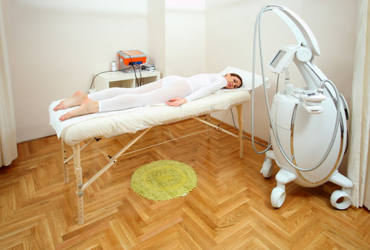 Woman having a treatment against cellulite in beauty salon