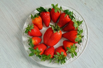 fresh strawberries on a white plate