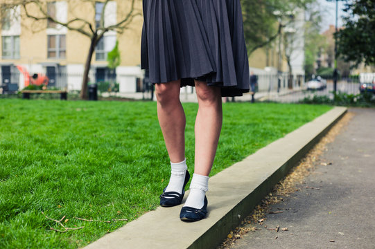 Woman wearing a skirt walking in park