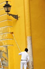 Man painting a facade with a roller