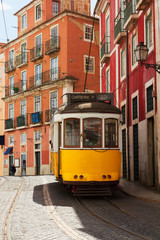Fototapeta na wymiar tram on narrow street of Alfama, Lisbon