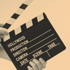Movie flapper in woman´s hands on white background