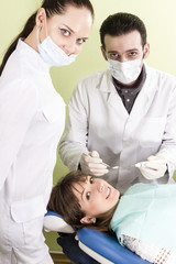Dentist assistant and the patient are ready for treating teeth