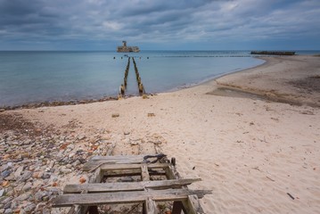 Sandy shore of Baltic sea and torpedownia near Gdynia.