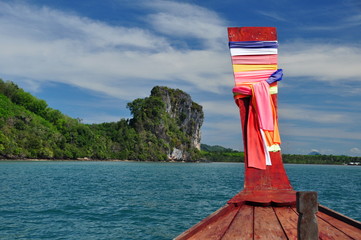 Limestone cliff viewed from a traditional Thai boat