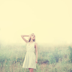 Fototapeta na wymiar beautiful young blond woman in a summer field