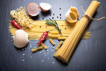 Different kinds of pasta, red chili pepper, rosemary, sea salt a