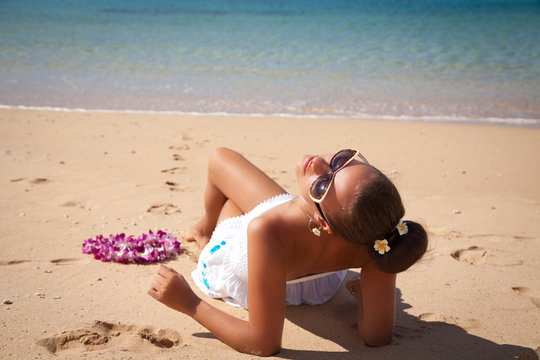 Young fashion woman relax on the beach, sun worshiper.