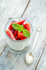 layered dessert with strawberries, chocolate biscuit cake and cr