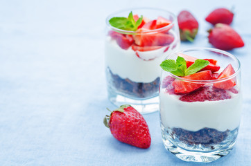 layered dessert with strawberries, chocolate biscuit cake and cr