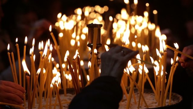 Church candles human hands