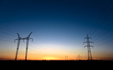 Large transmission towers at blue hour