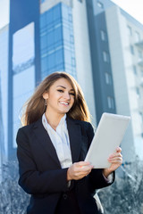 Successful businesswoman or entrepreneur using a digital tablet