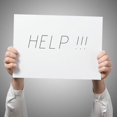 Hands holding placard billboard poster with text HELP