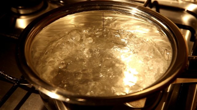A close view of water boiling in a stainsess steel pot
