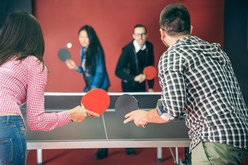 Couples playing ping pong
