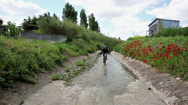 mountain bicycle riding in a brook in the countryside